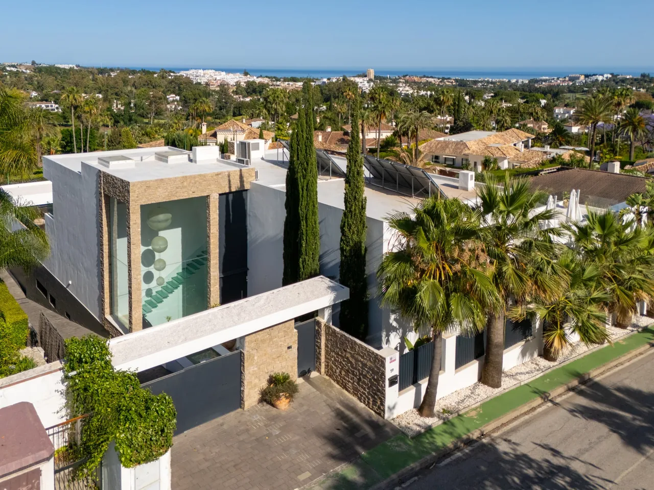 Guadalmina beachfront villa with mature gardens, palm trees and Mediterranean Sea horizon